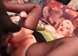 Blonde fucked by a black dog on a bed